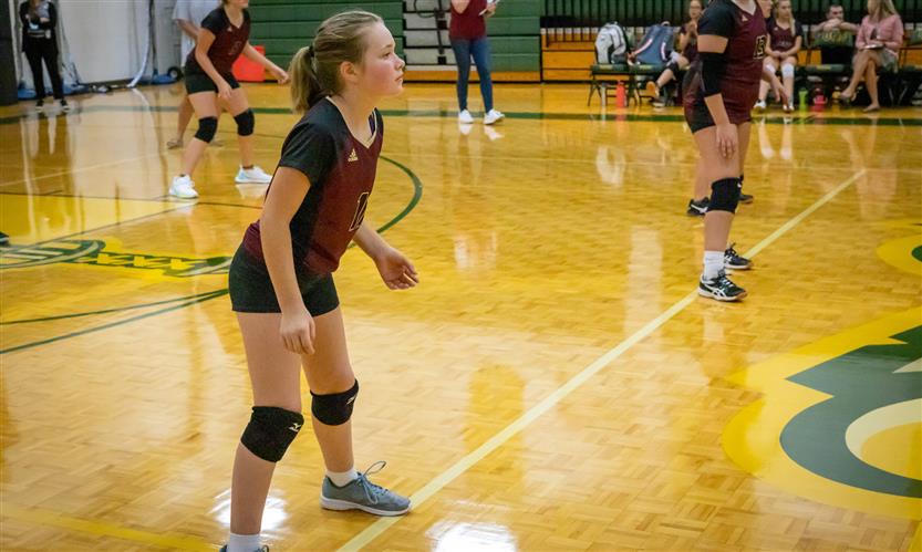 A volleyball player waits for a serve